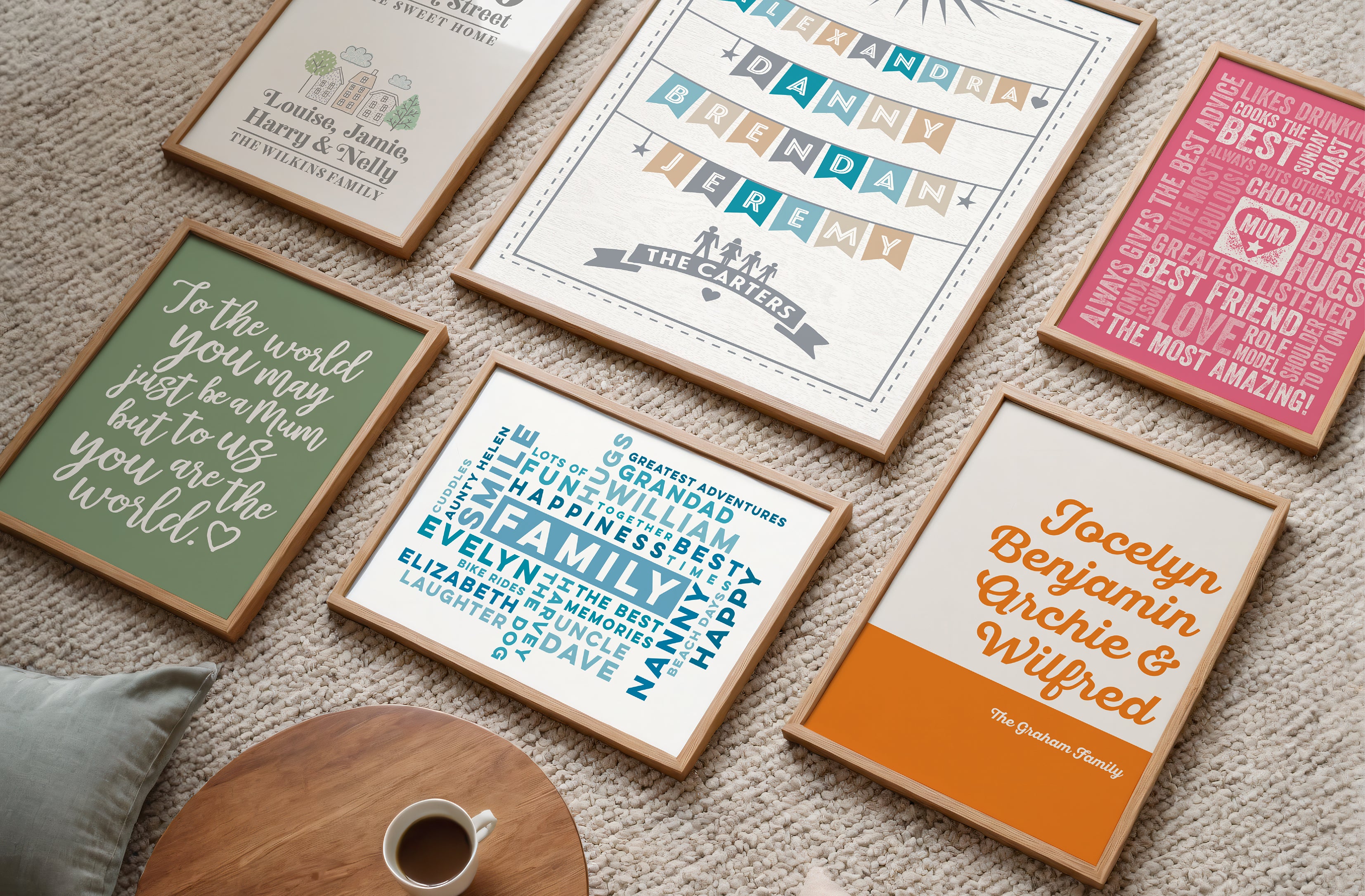 Collection of framed personalised prints on a carpeted floor.